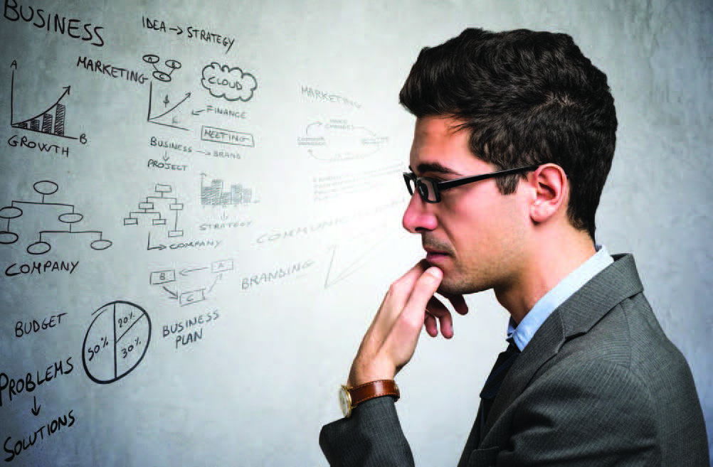 Man looking at whiteboard creating your next practice